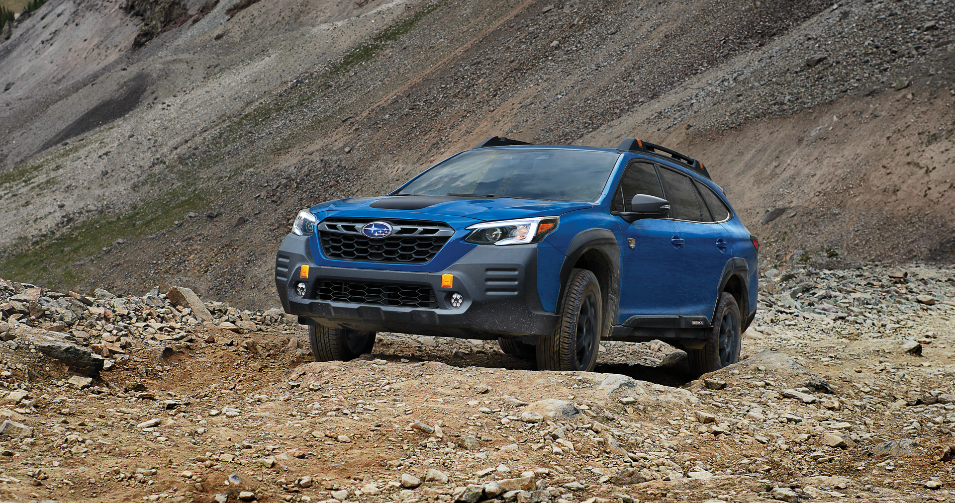 A 2023 Outback Wilderness driving on a trail in the mountains. | Sommer's Subaru in Mequon WI