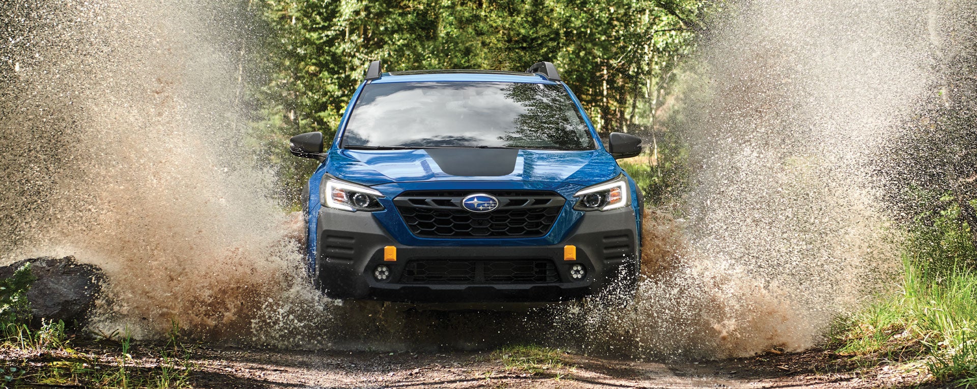 A 2023 Outback Wilderness driving on a muddy trail. | Sommer's Subaru in Mequon WI