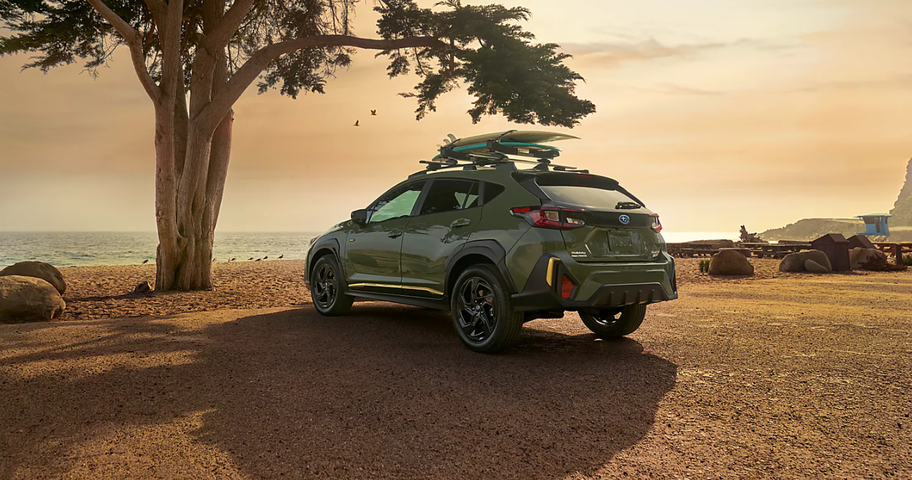 Rear view of the 2024 Subaru Crosstrek, parked in front of a beach