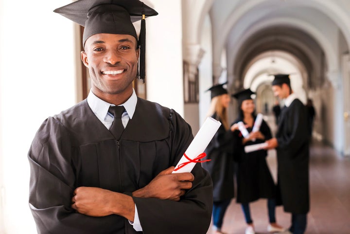college graduate holding his diploma | Sommer's Subaru in Mequon WI