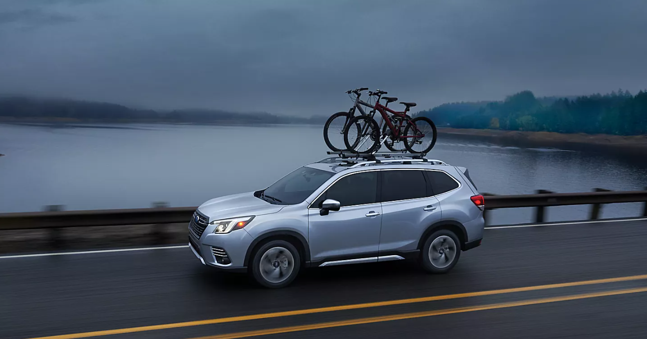 2023 Subaru Forester Trim Comparison 2023 Subaru Forester Touring in Ice Silver Metallic with bicycles attached to the roof with equipment